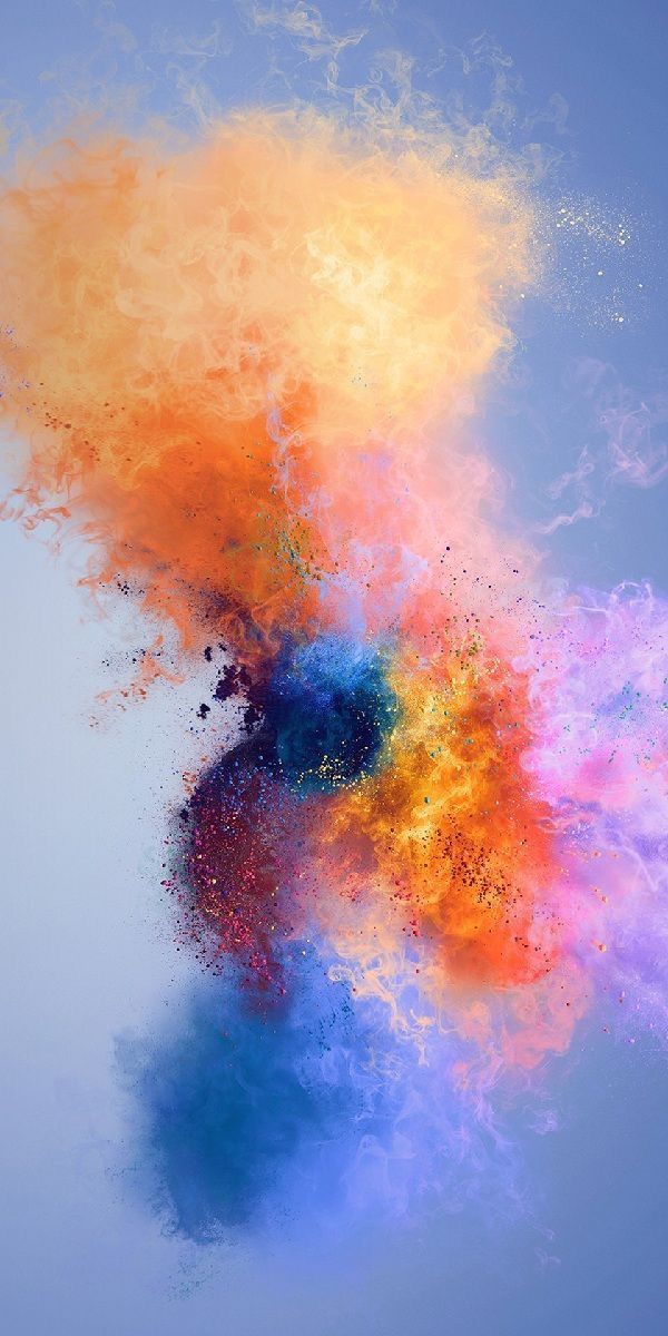 An explosion of orange and blue powder on a pale blue background.