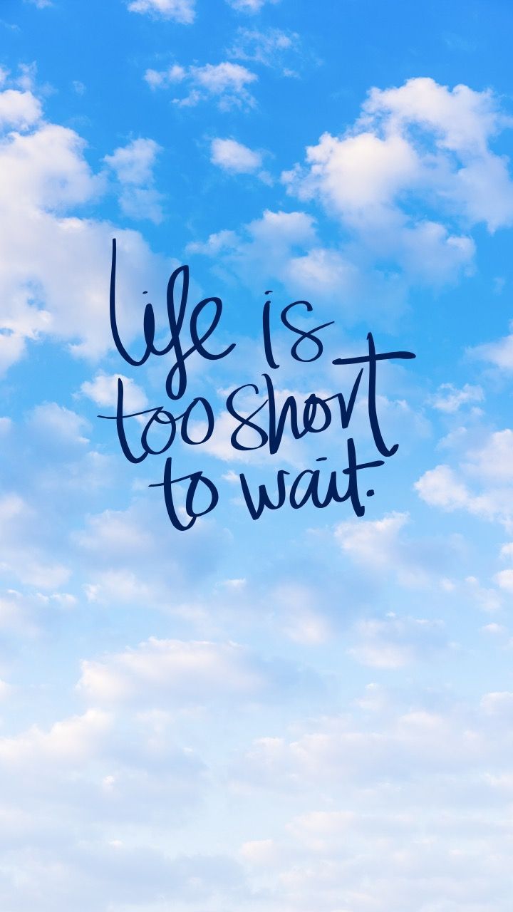 "Life is too short to wait" in black handwriting over a blue sky with white clouds.