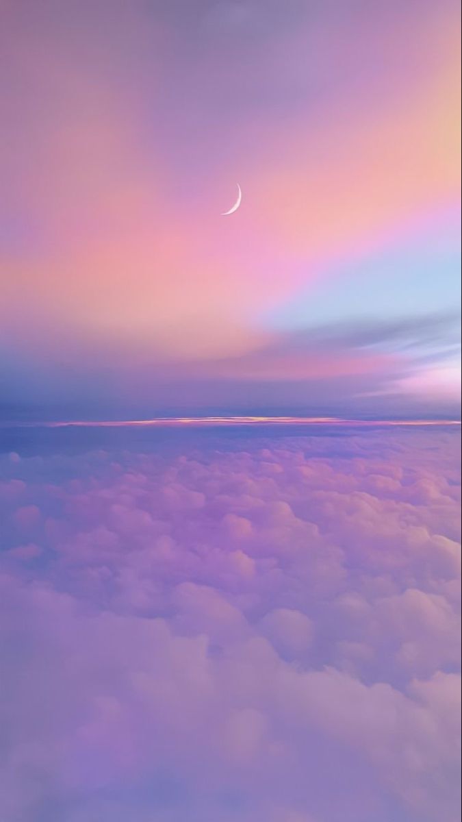A pastel sea of clouds under a blue, pink and lilac sky with a crescent moon.