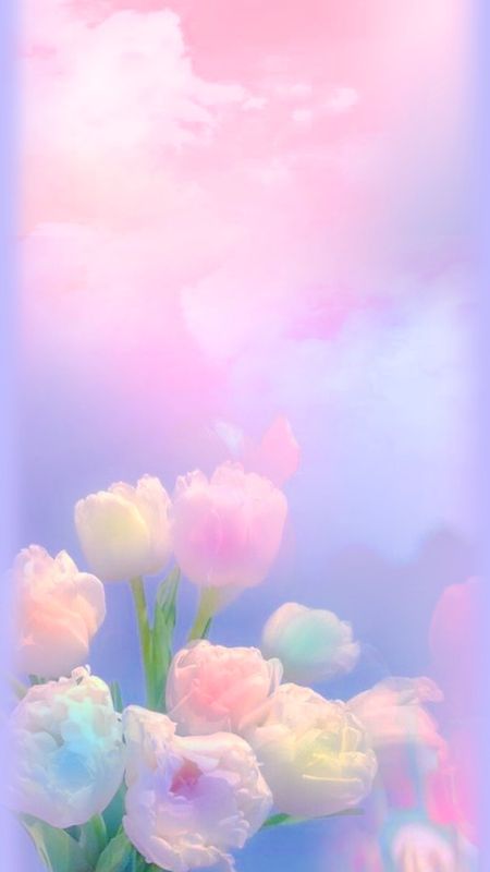 Pastel tulips in soft pink, yellow and blue under a hazy lilac sky.