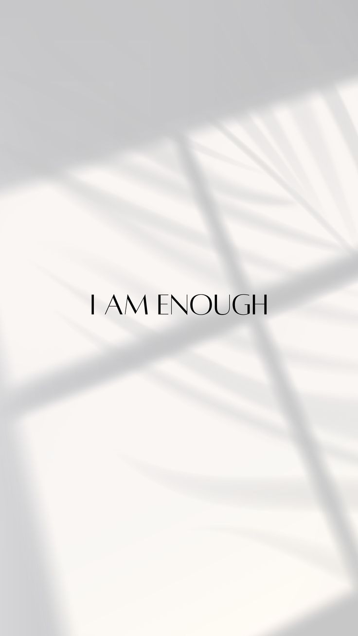 "I am enough" in small black serif type on white with soft window shadows.