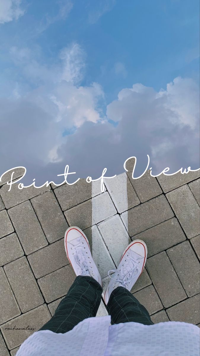 "Point of view" in white script over a person's white trainers on grey paving under clouds.