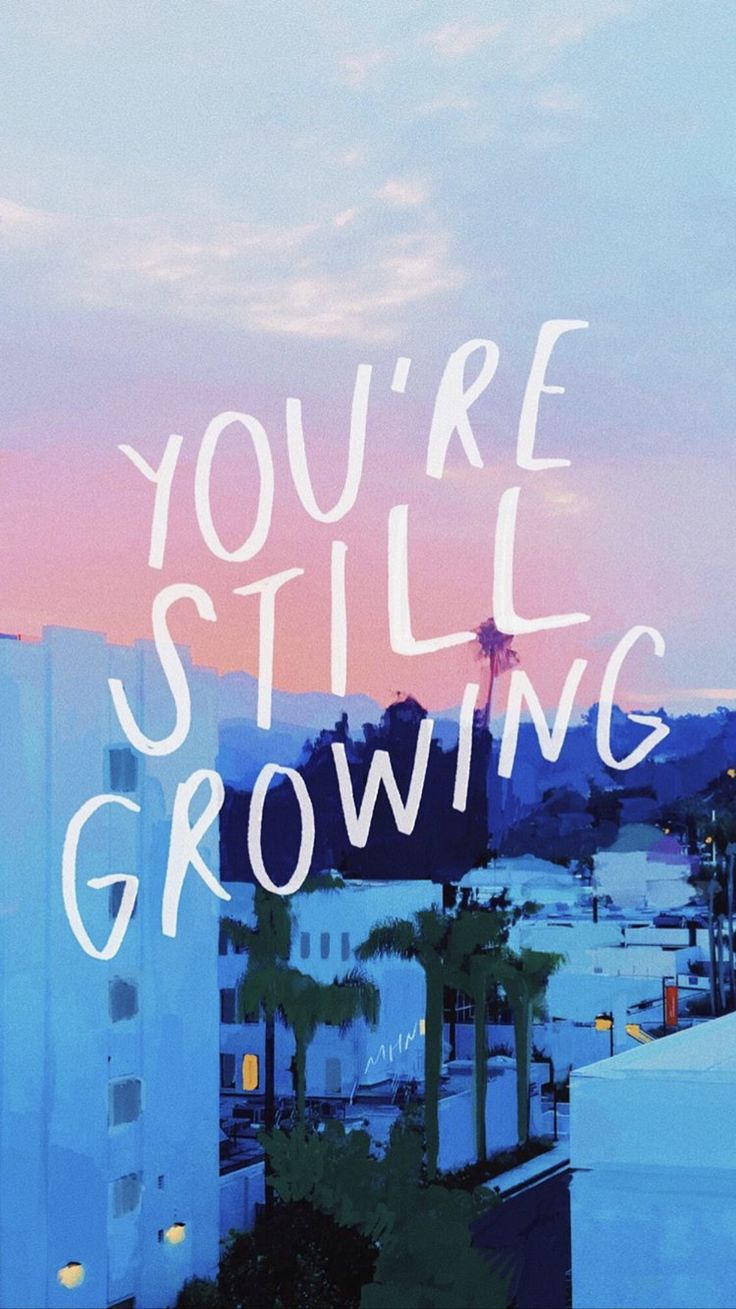 "You're still growing" in large white letters over a sunlit city street at dusk.