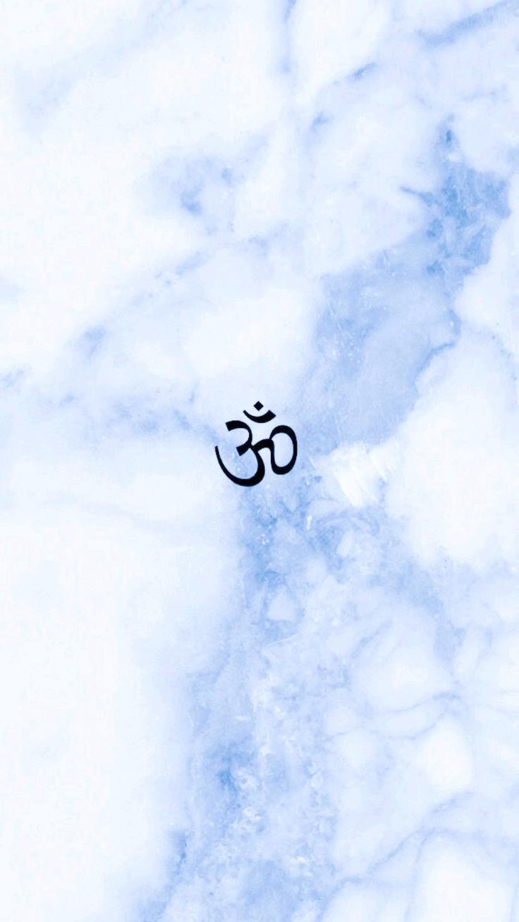 A small black Om symbol on white and blue marble.