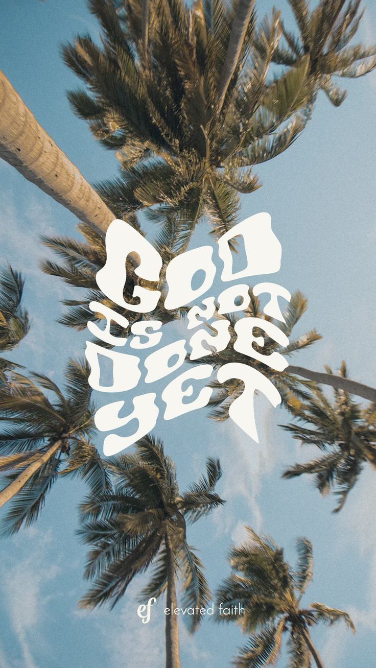 "God is not done yet" in white wavy letters over tall palm trees against a blue sky.